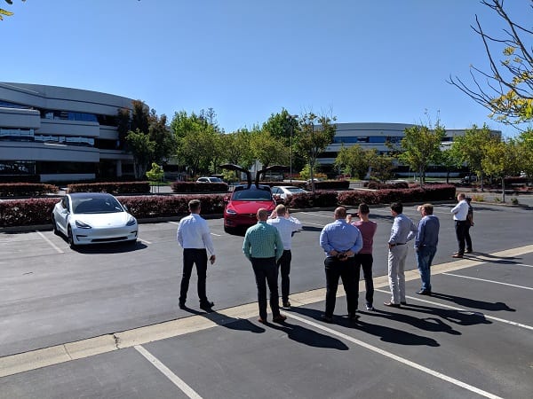 Executives from Volkswagen Bank Poland survey the Tesla Model S as part of their immersion program in Silicon Valley.